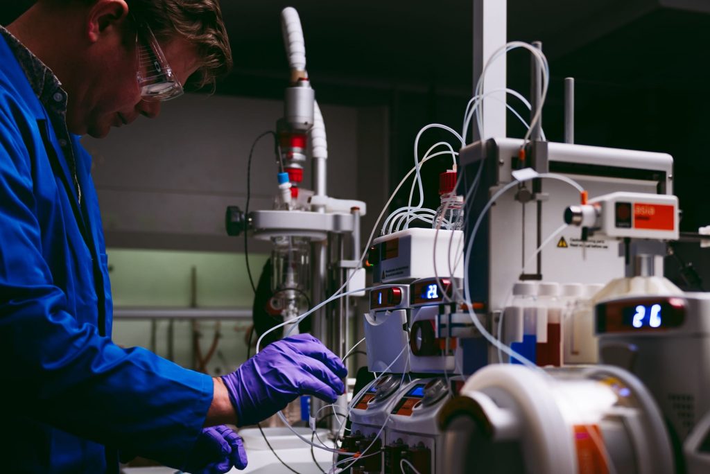 A chemist using Syrris a Asia flow chemistry system in a lab