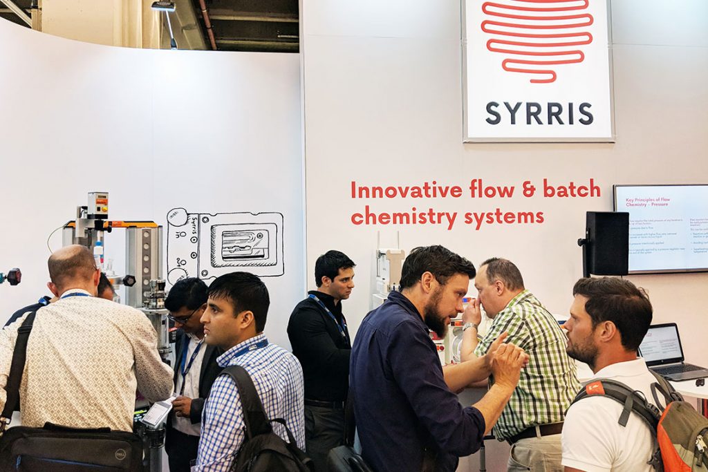 Syrris' booth at Achema conference, showing batch and flow products